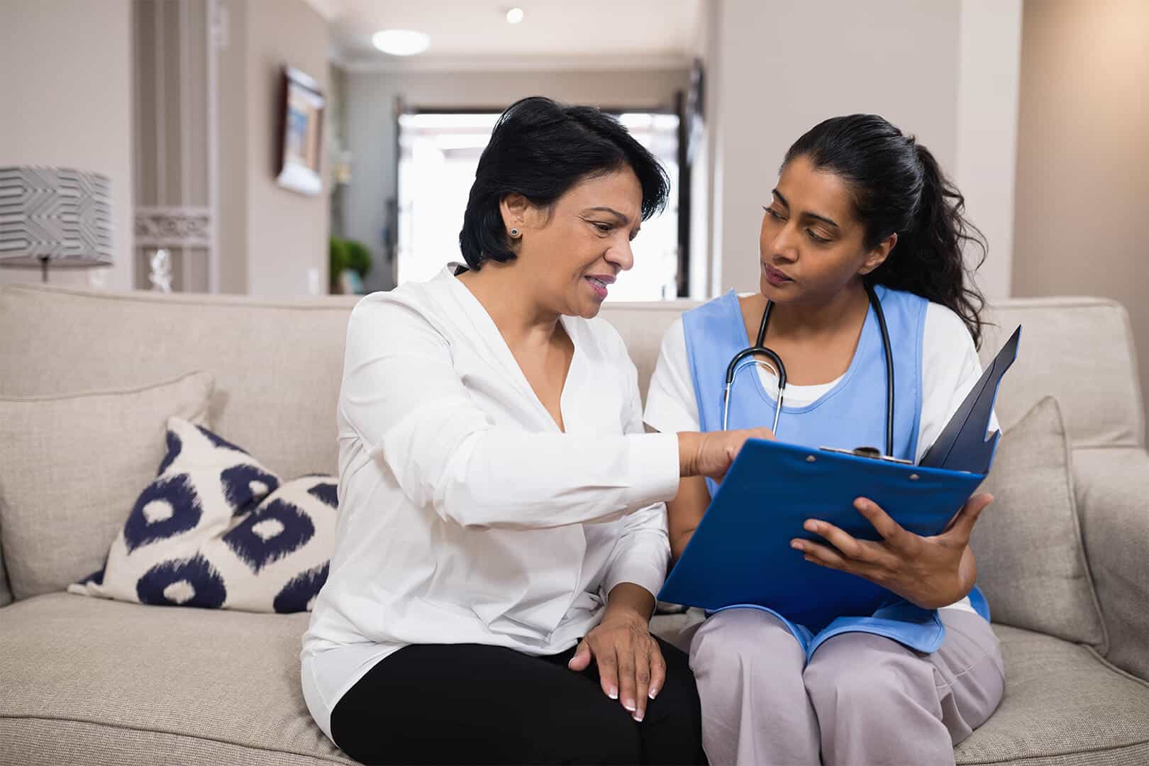 Female caregiver working with female resident