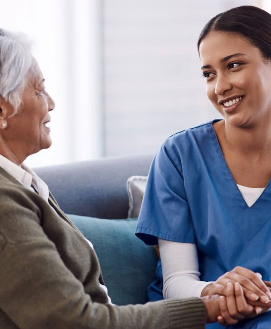 Female caregiver, holding hand with older woman