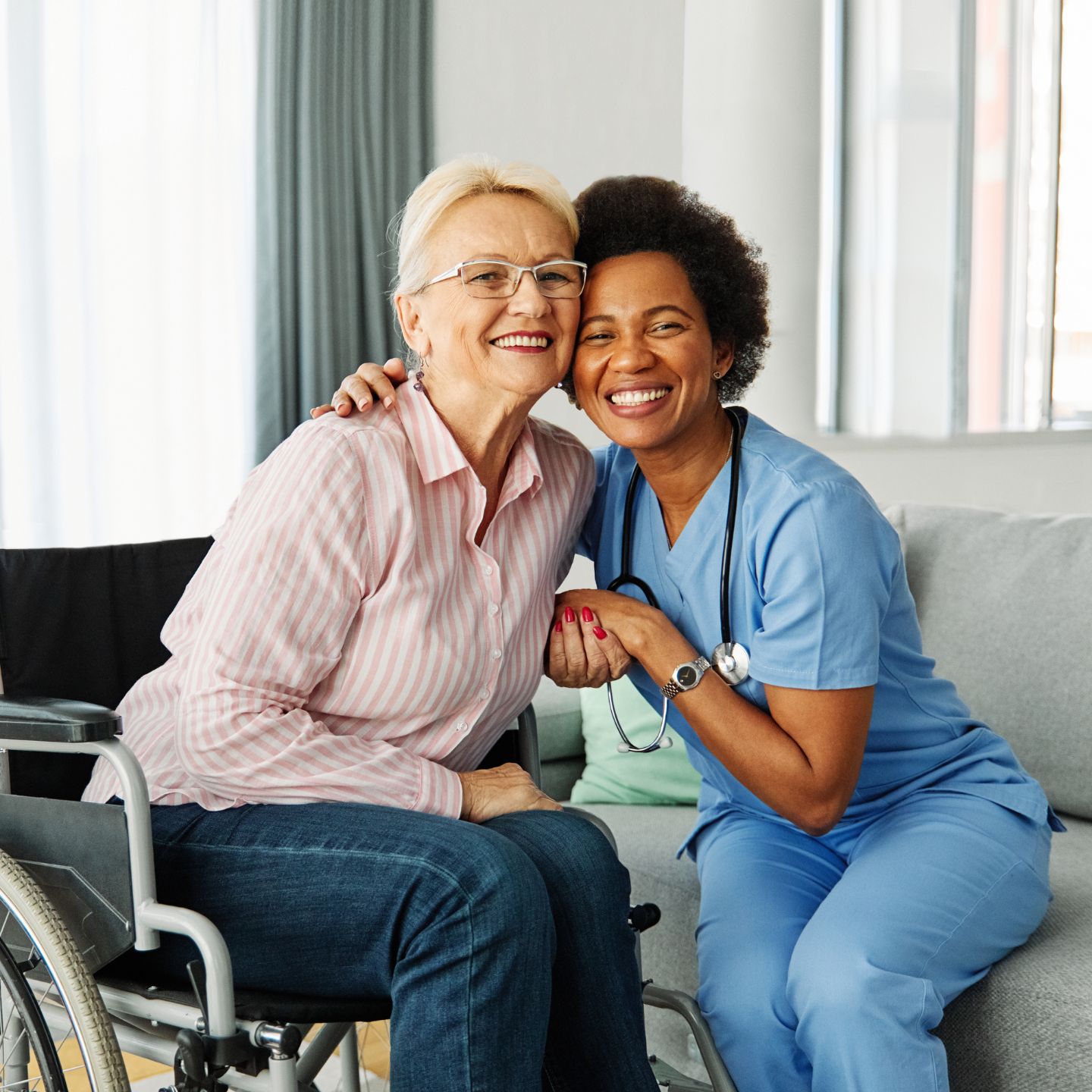 Caregiver and dementia patient sitting next to each other